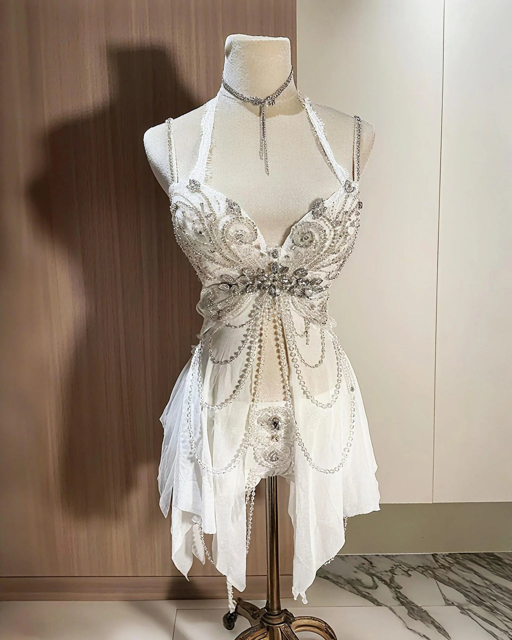 AVRY Aurora Moth white butterfly rave outfit with corset top, matching bottom and pearl chain details.