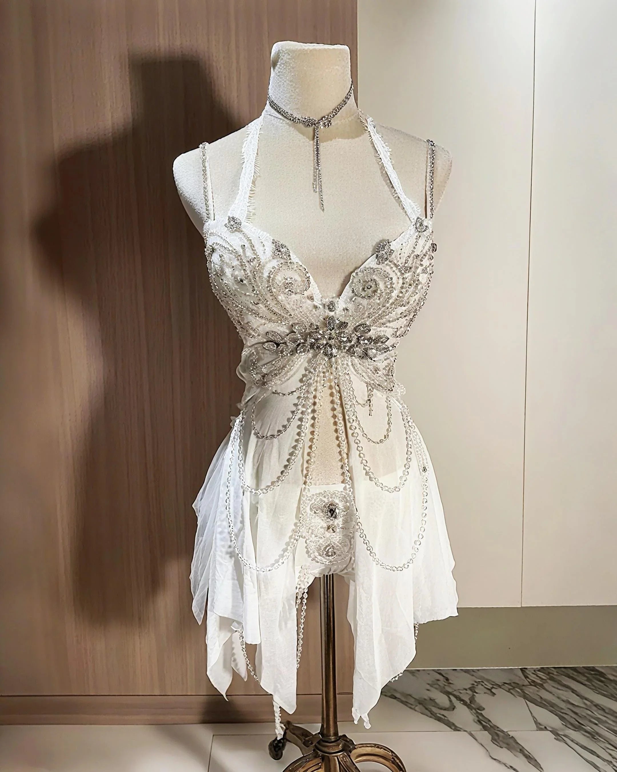 AVRY Aurora Moth white butterfly rave outfit with corset top, matching bottom and pearl chain details.