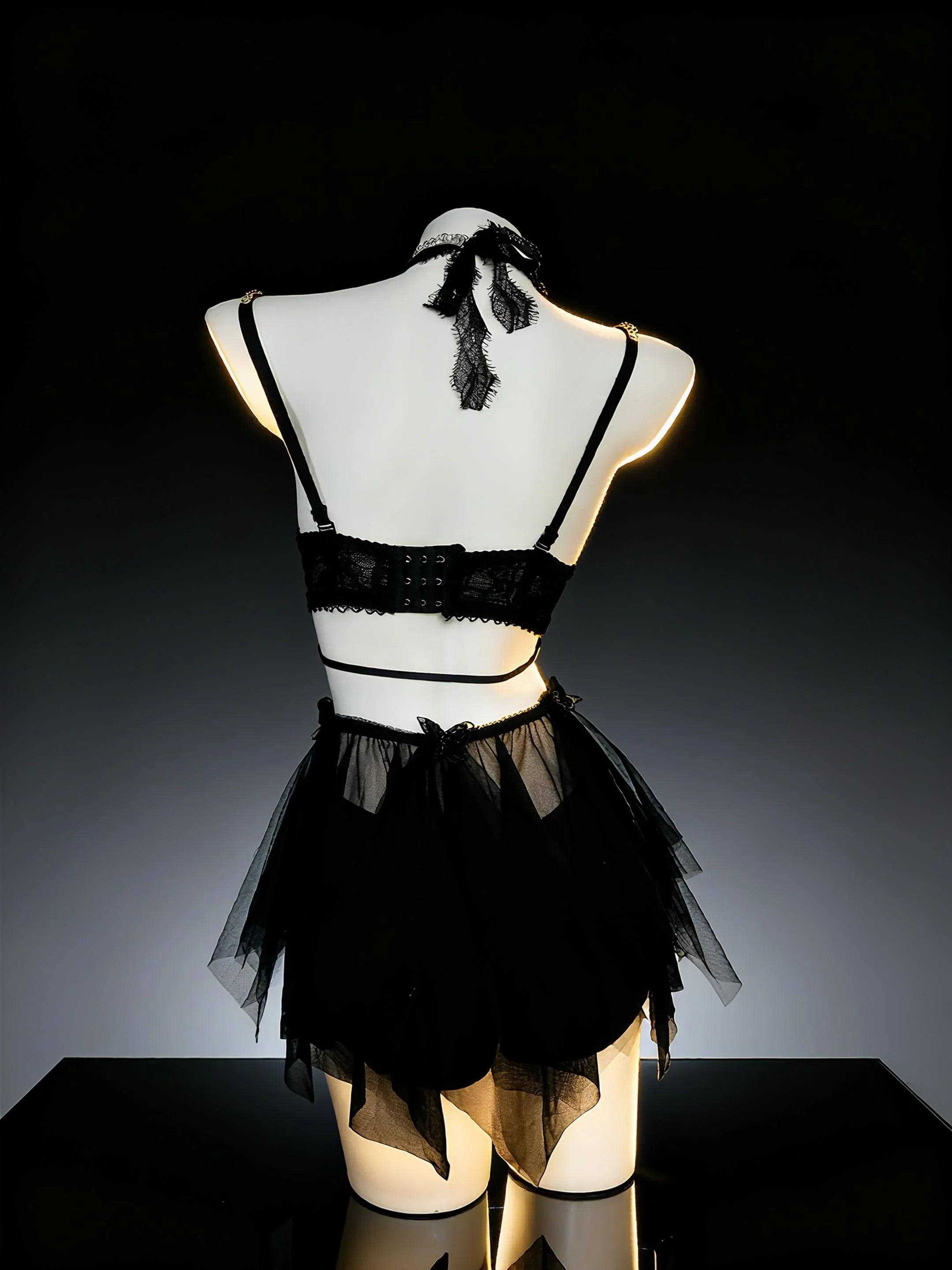 AVRY Noir Monarch back view showing black ruffle bottom, gothic straps and dramatic festival outfit styling.