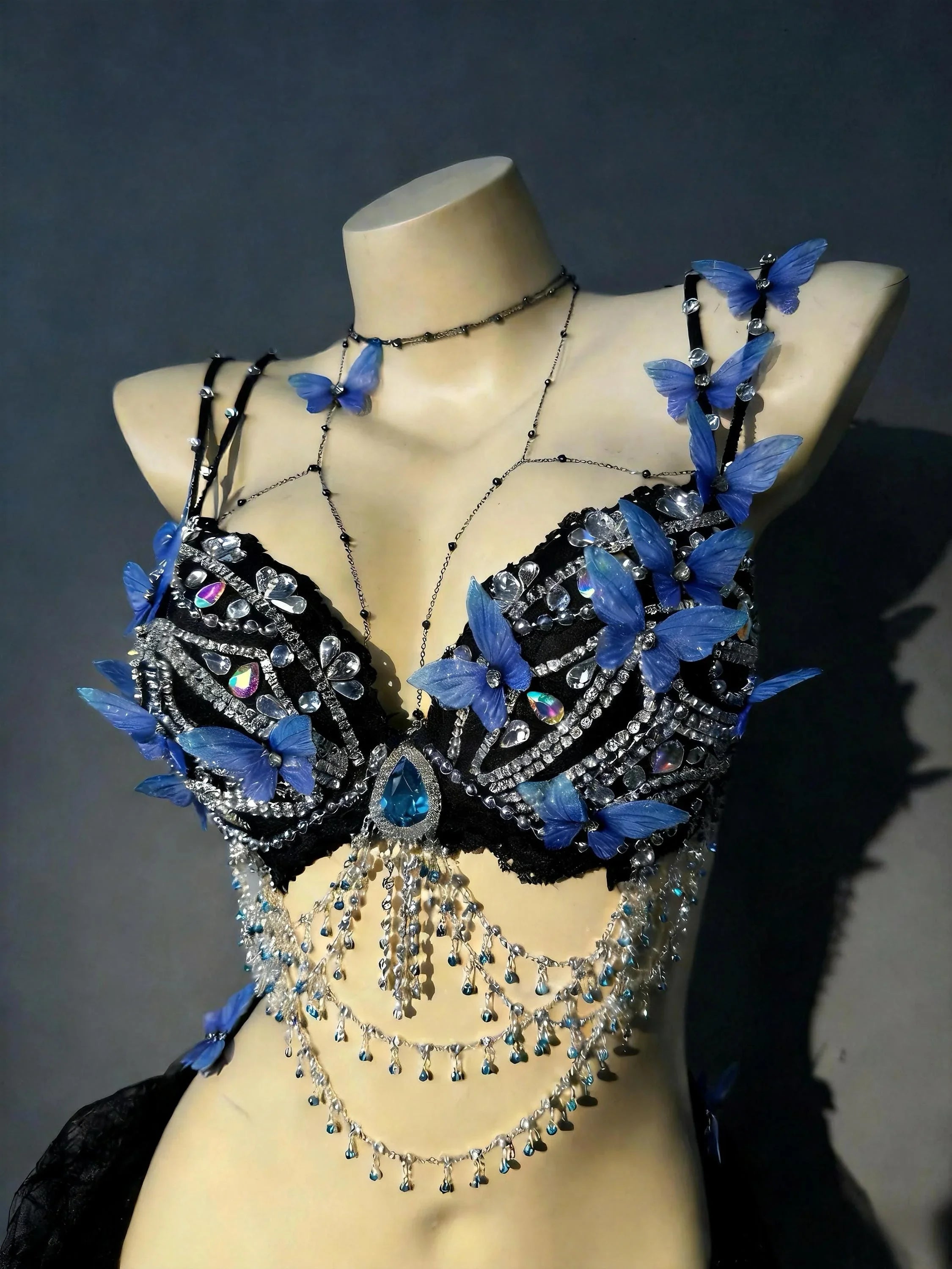 AVRY Azure Morpho side view showing butterfly bra top, body chain accents and black tulle wrap skirt.