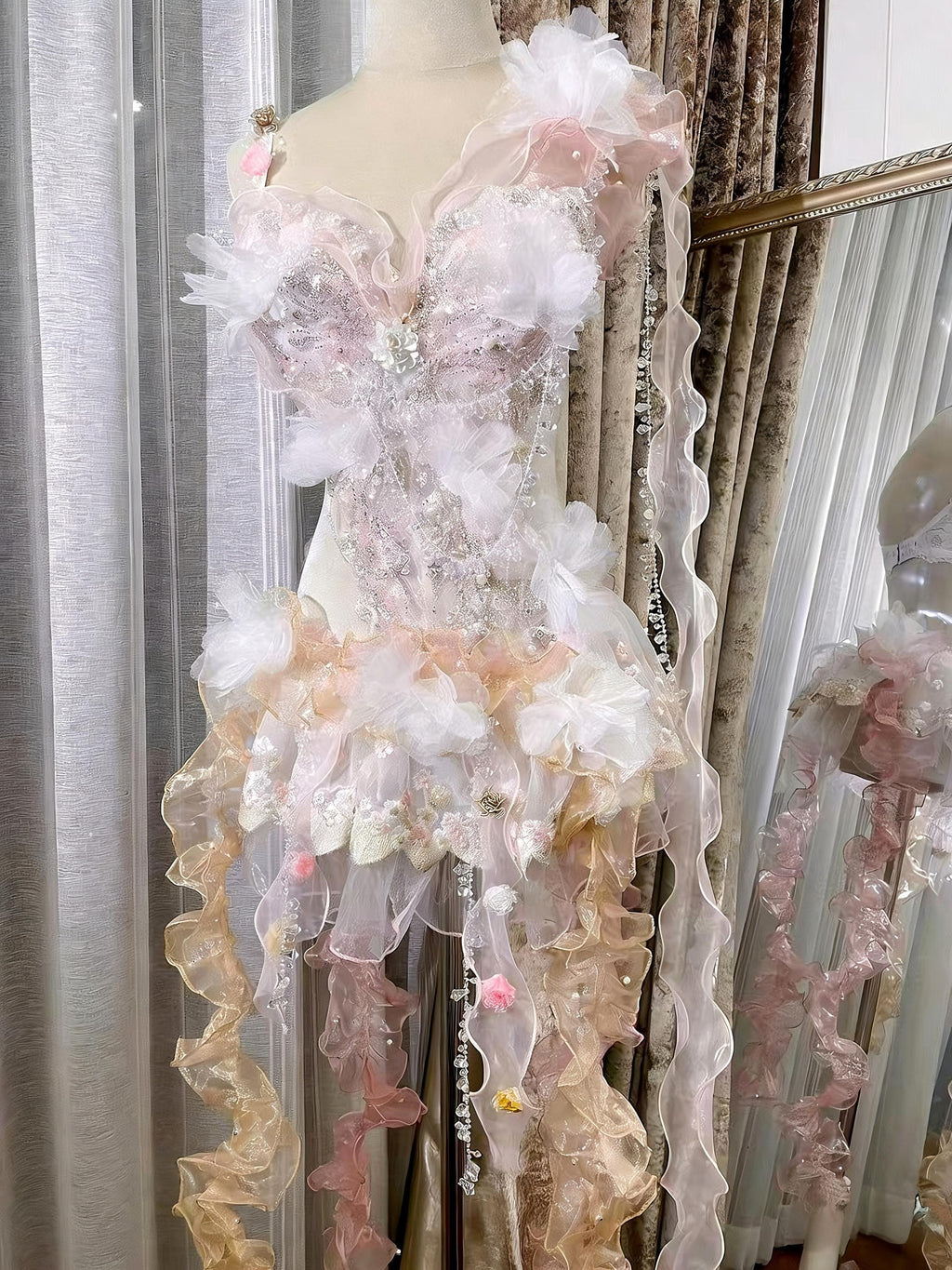AVRY Camellia Set pastel fairy rave bodysuit with floral details, organza ruffles and flowing ribbon accents.