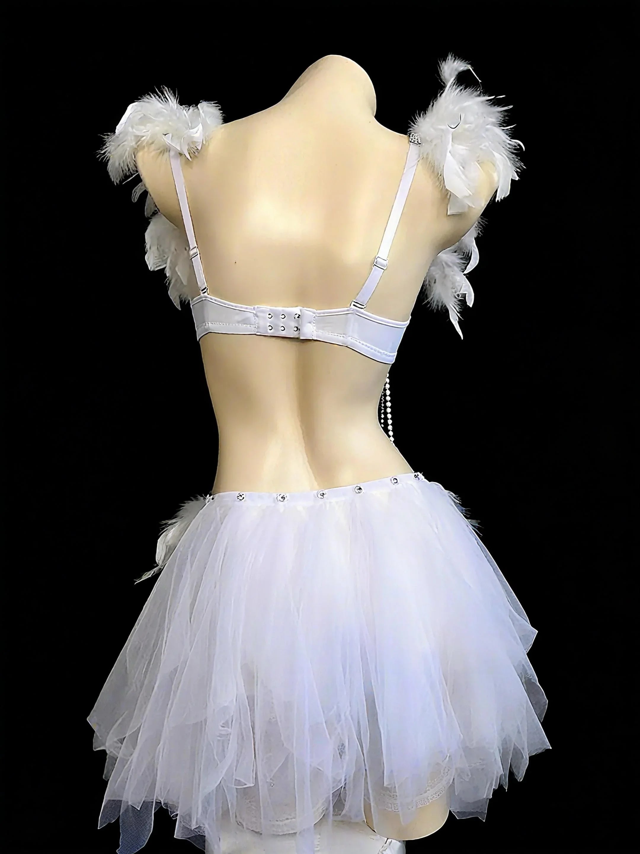 AVRY Dovea Set side view showing white feather top, layered textures and ethereal festival outfit details.