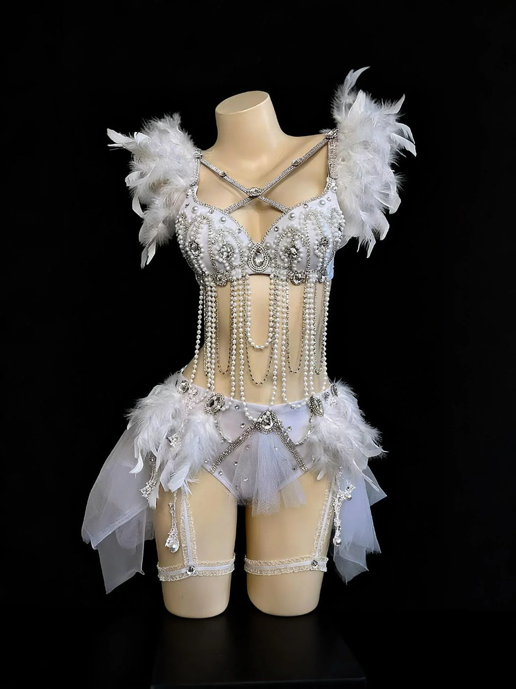 AVRY Dovea Set white feather rave outfit with feather bra top, matching bottom and sheer wrap skirt.