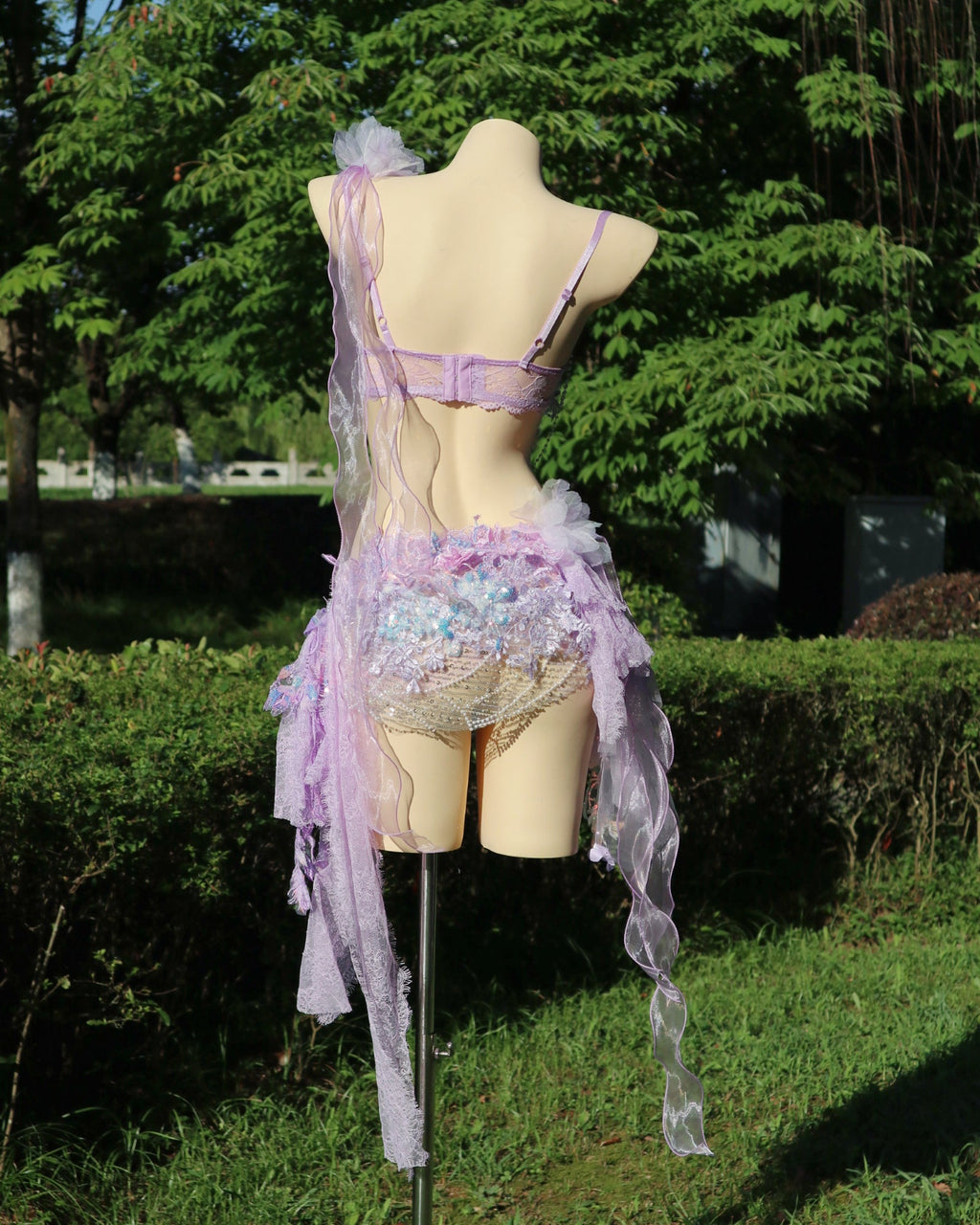 Back view of the AVRY New Forest Purple Rosalie fairy festival set with adjustable bra straps, embellished skirt and cascading lilac ribbon details.
