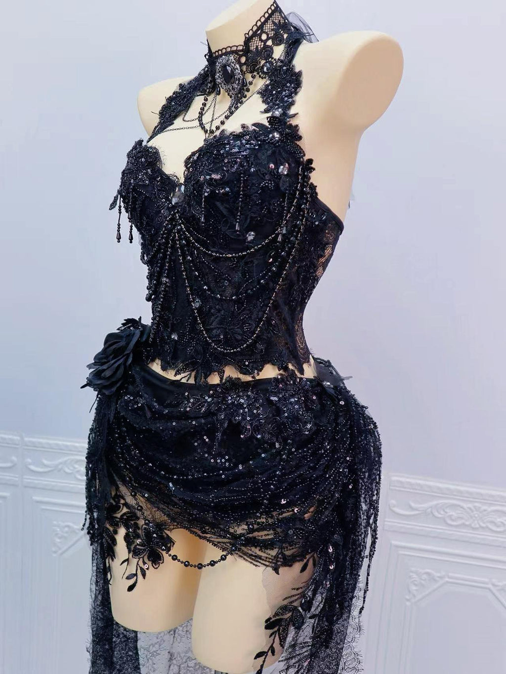 AVRY Odette Set side view showing draped chains, black lace texture and dark fairy rave outfit styling.