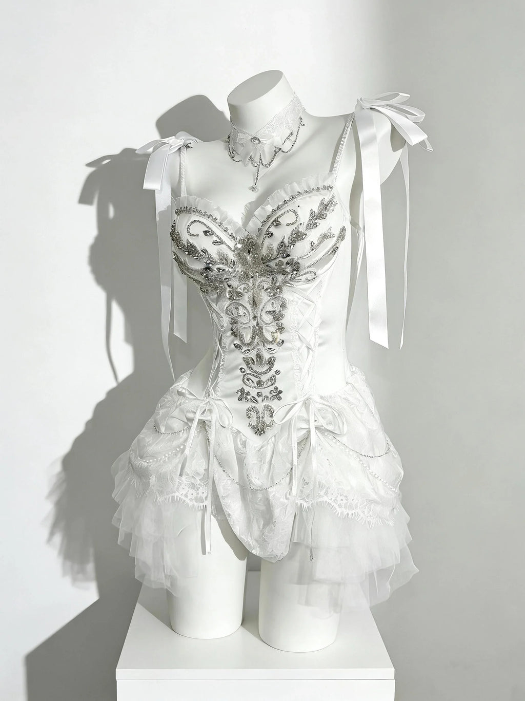 Fairycore corset dress with white lace, silver details, and soft draping
