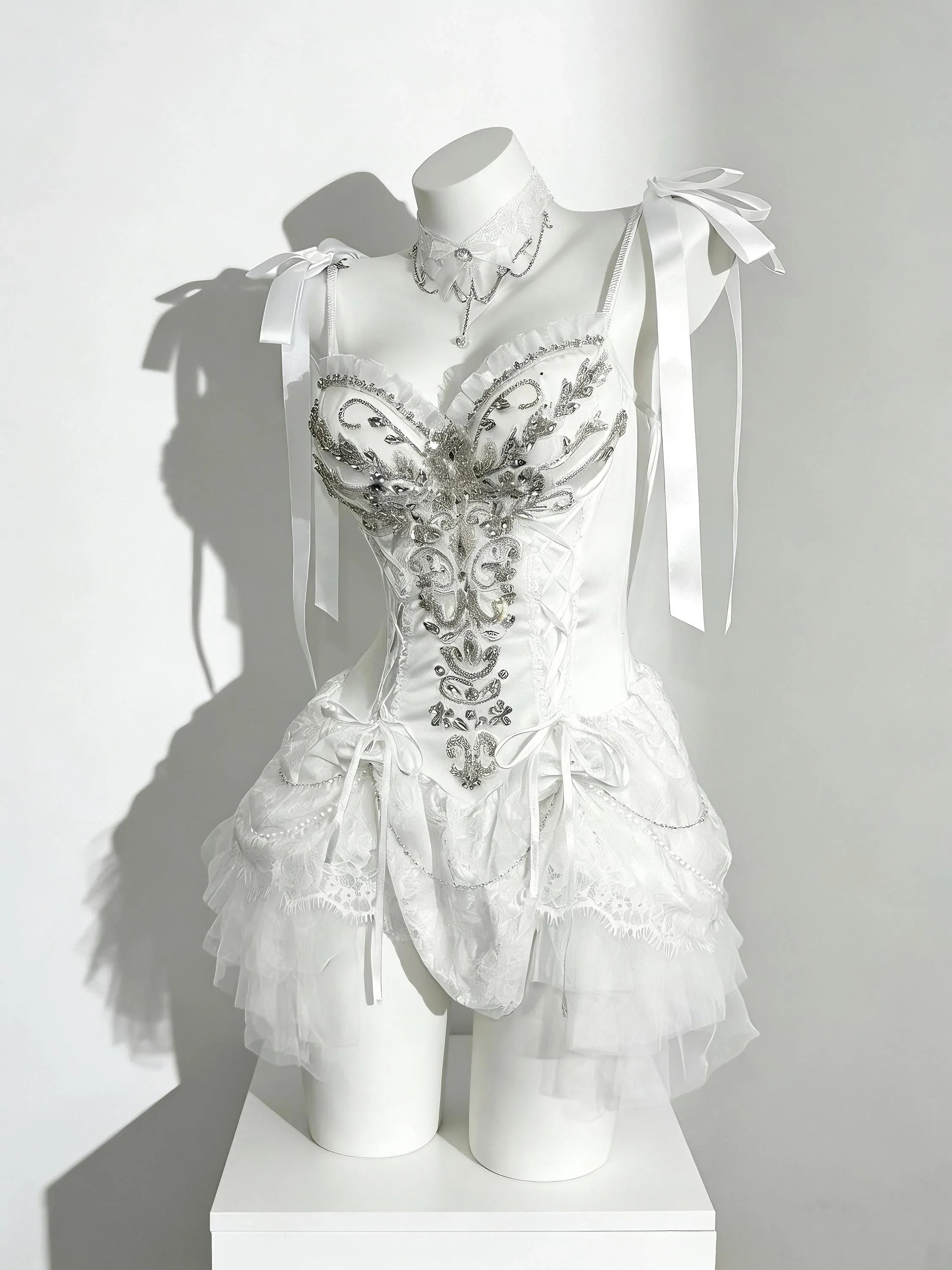 Fairycore corset dress with white lace, silver details, and soft draping